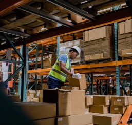 Warehouse worker stacking boxes