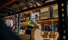 Warehouse worker stacking boxes