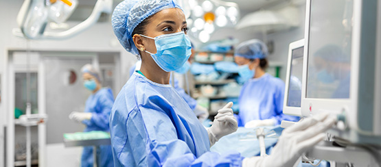 A medical professional in disposable protective gear