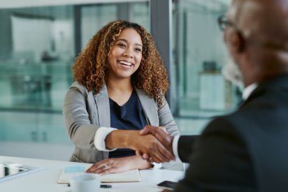 A woman shakes a man's hand