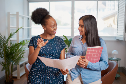 Two women work together