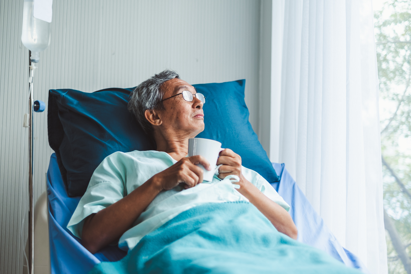 An older man in a hospital bed