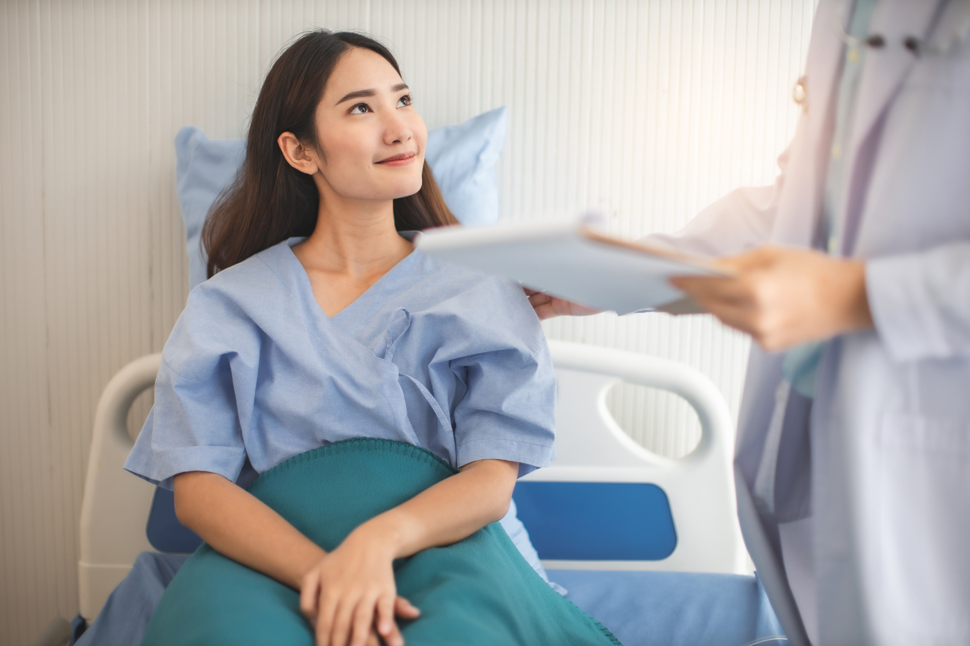 A patient wearing a blue hospital gown